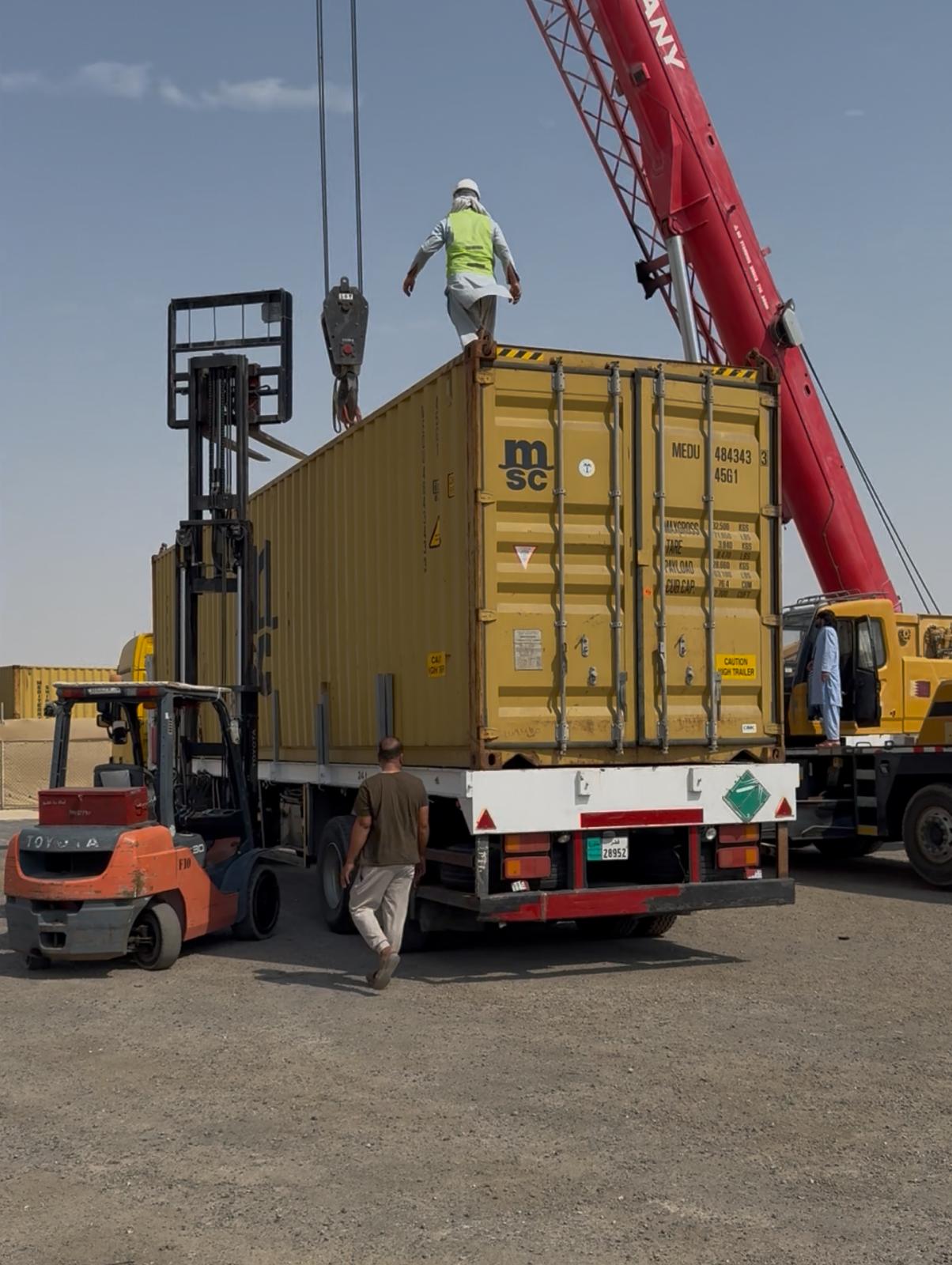 Crane lifting shipping container
